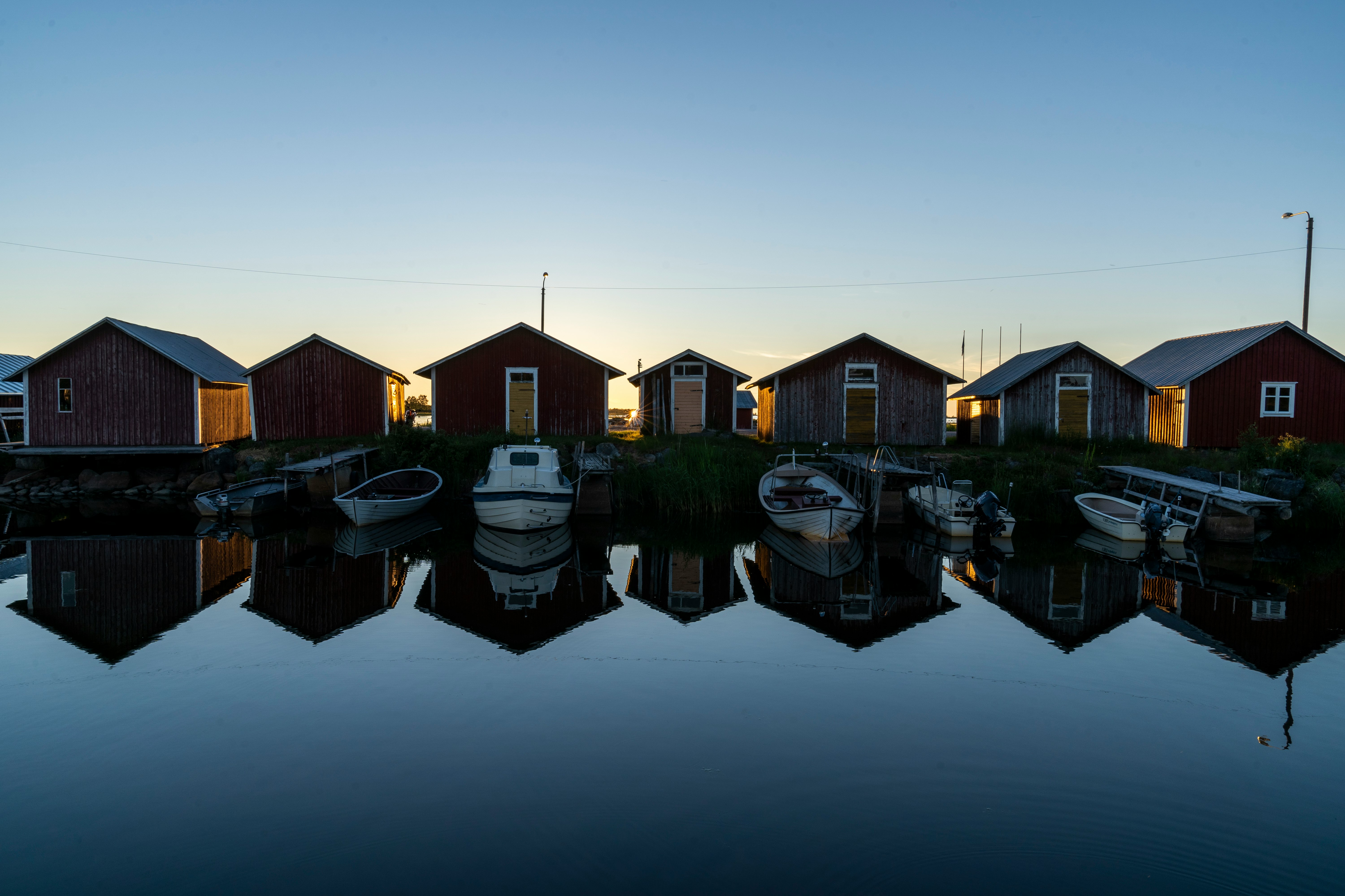 brown and white houses beside body of water during daytime